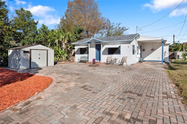 single story home with a carport and a storage shed