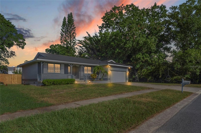 view of front of house featuring a garage and a lawn