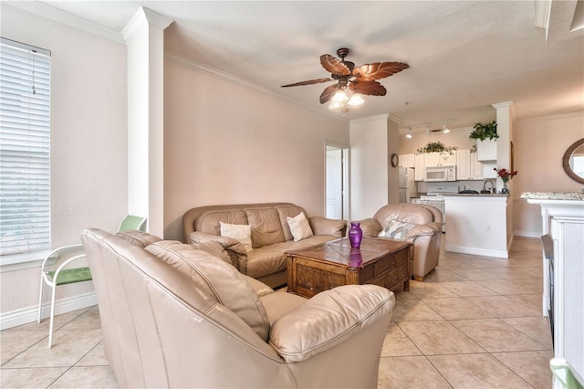 tiled living room featuring ornamental molding, a textured ceiling, sink, and ceiling fan