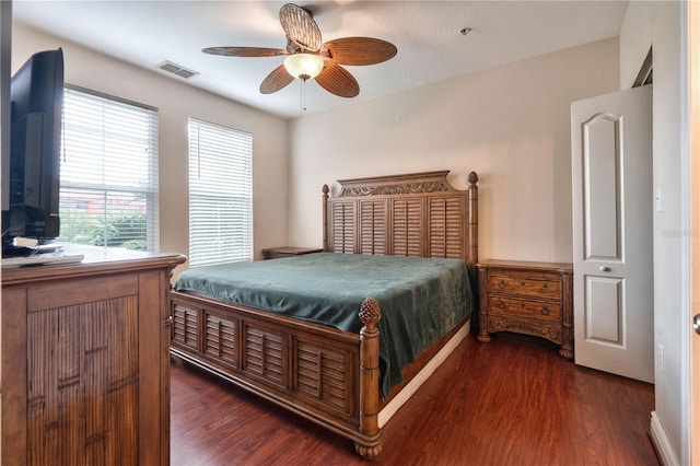 bedroom with ceiling fan and dark hardwood / wood-style floors