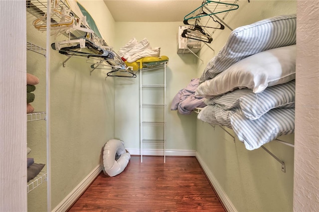 walk in closet featuring dark hardwood / wood-style flooring