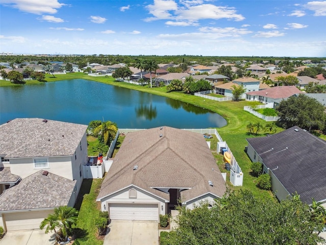 birds eye view of property with a water view and a residential view