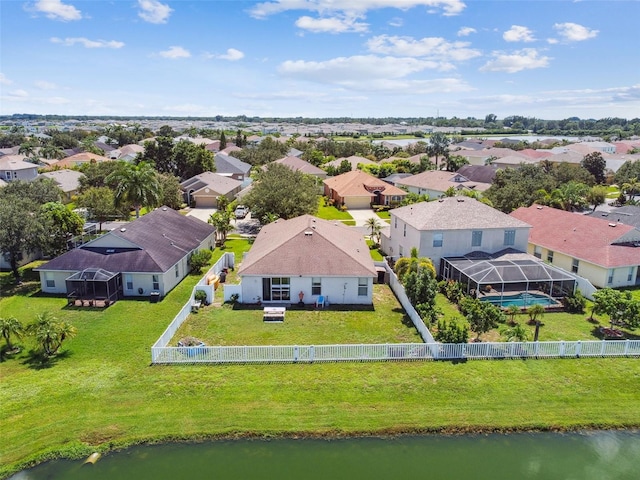 birds eye view of property with a water view and a residential view