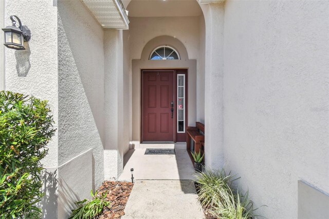 property entrance featuring stucco siding