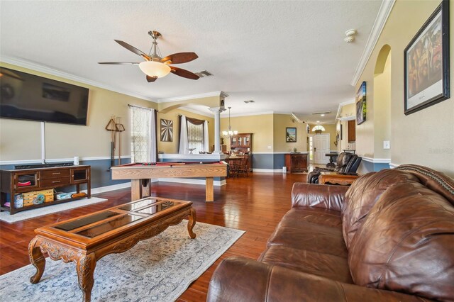 living room featuring arched walkways, crown molding, wood-type flooring, pool table, and ceiling fan with notable chandelier