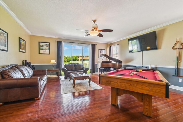 recreation room featuring pool table, hardwood / wood-style floors, ornamental molding, a ceiling fan, and baseboards