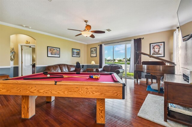 rec room with arched walkways, wood finished floors, a ceiling fan, and crown molding