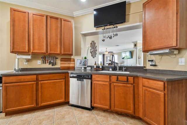 kitchen featuring crown molding, dark countertops, brown cabinetry, a sink, and dishwasher