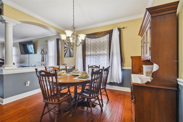 dining area with baseboards, arched walkways, ornamental molding, dark wood-type flooring, and ornate columns