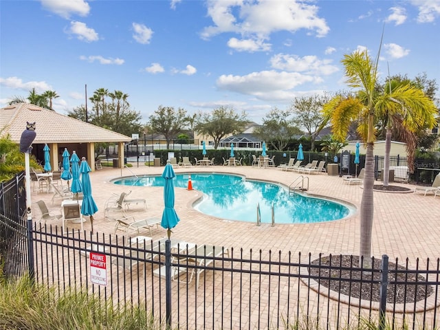 pool featuring a patio area and fence