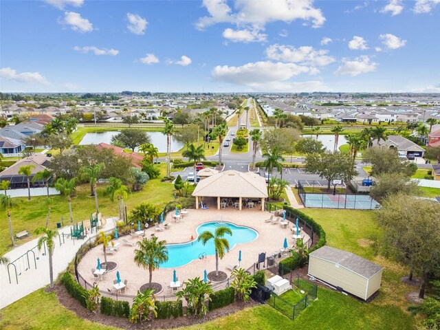 drone / aerial view featuring a water view and a residential view