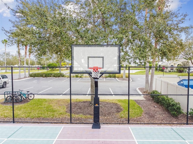 view of basketball court featuring community basketball court and fence