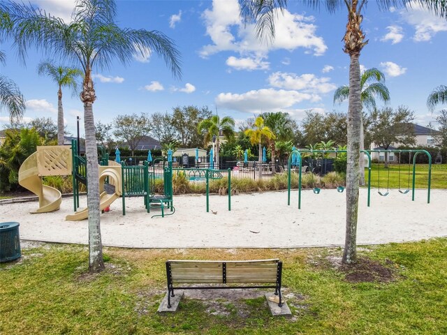 exterior space featuring playground community and a lawn