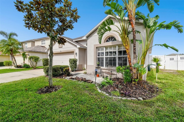 view of front of home featuring a garage and a front lawn