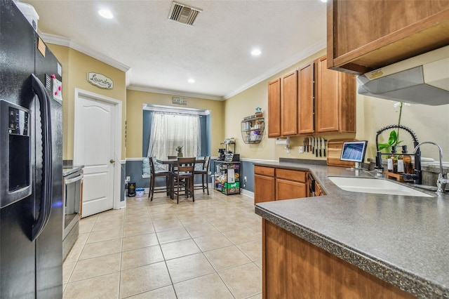 kitchen with crown molding, dark countertops, black fridge with ice dispenser, and a sink