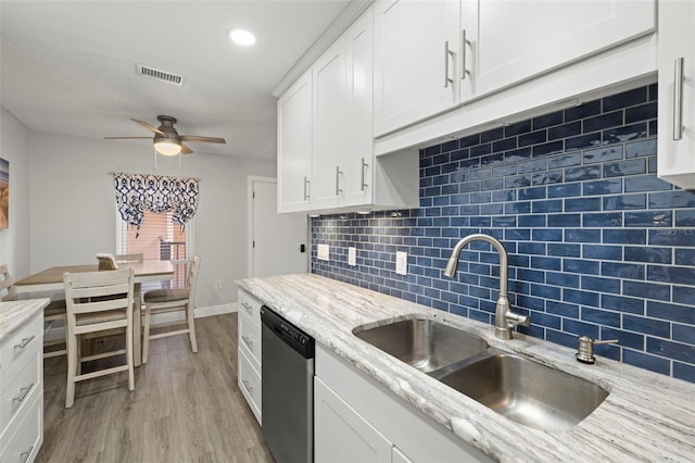 kitchen featuring dishwasher, light hardwood / wood-style floors, sink, ceiling fan, and decorative backsplash