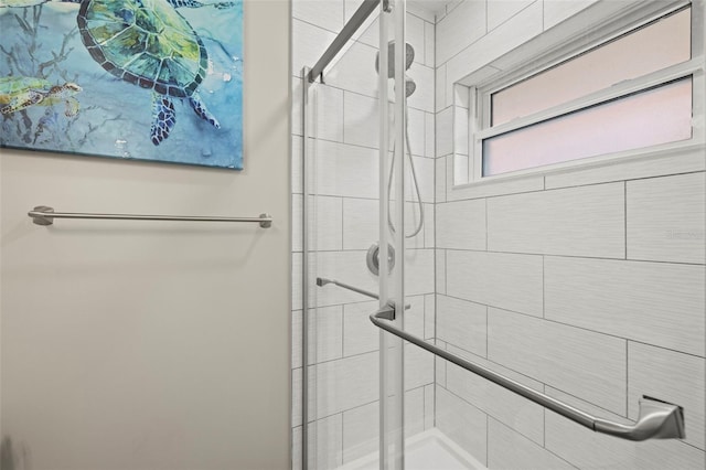 bathroom featuring a shower with door