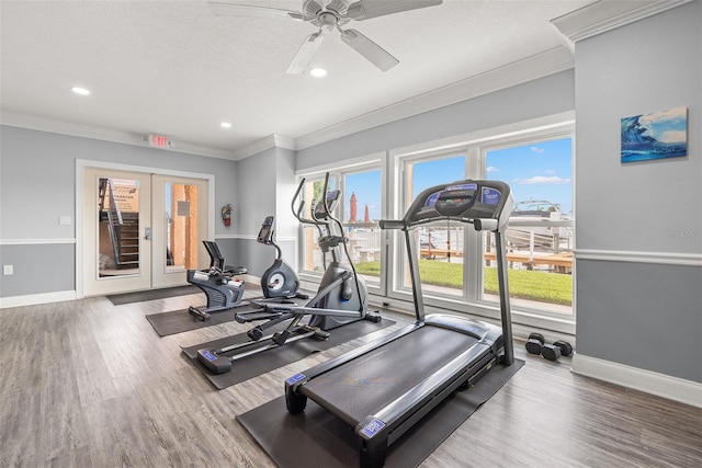 exercise room featuring crown molding, a textured ceiling, hardwood / wood-style flooring, and ceiling fan