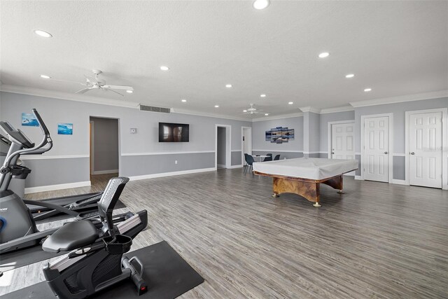 interior space featuring crown molding, billiards, ceiling fan, and dark hardwood / wood-style floors