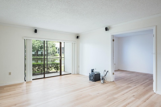 empty room with a textured ceiling and light wood-type flooring