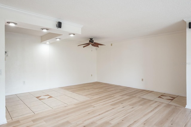 unfurnished room featuring ornamental molding, a textured ceiling, ceiling fan, and light hardwood / wood-style floors