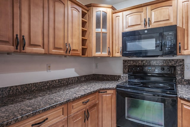 kitchen featuring black appliances and dark stone counters