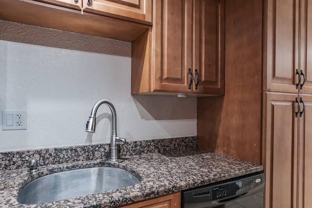 kitchen with black dishwasher, sink, and dark stone counters