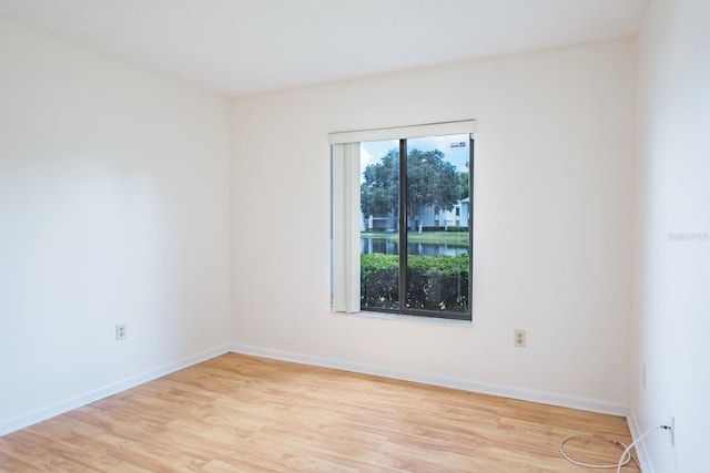 empty room with light hardwood / wood-style flooring