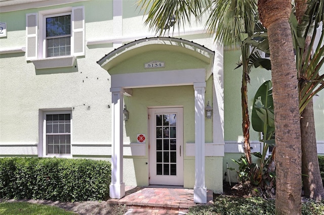 entrance to property featuring stucco siding