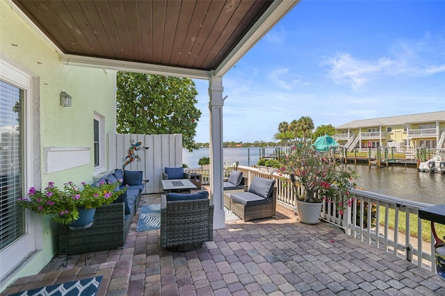 view of patio / terrace with a water view and an outdoor living space