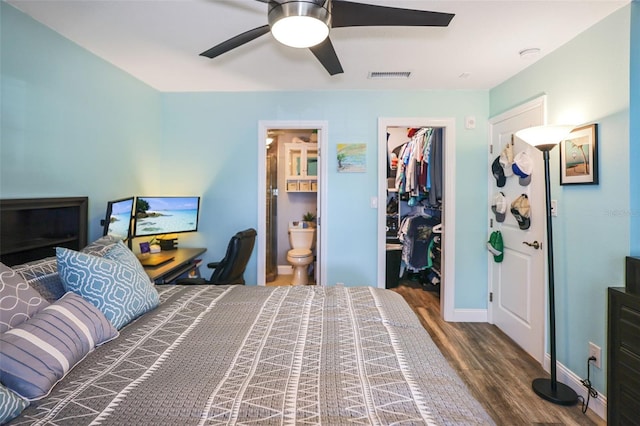 bedroom featuring visible vents, ceiling fan, wood finished floors, a spacious closet, and a closet