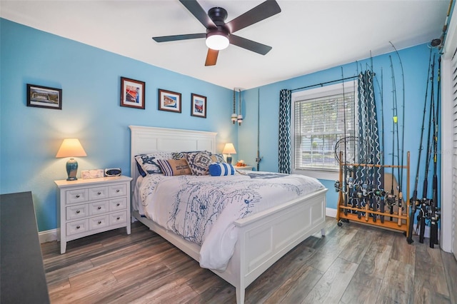 bedroom featuring ceiling fan, wood finished floors, and baseboards