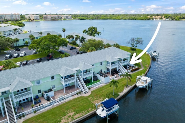 birds eye view of property with a water view