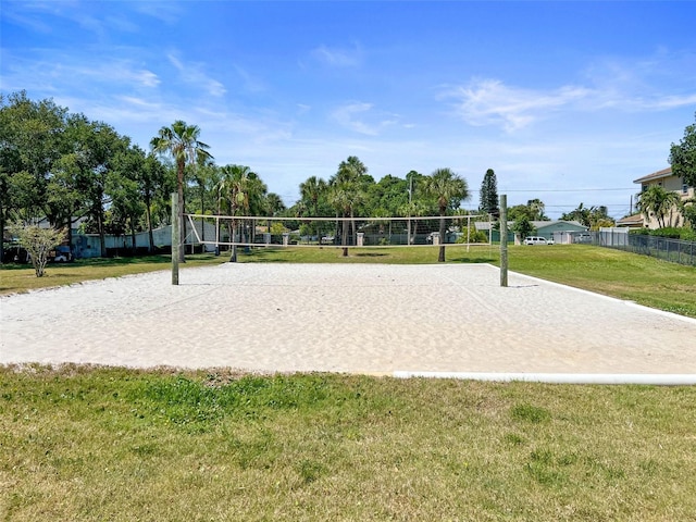 view of home's community featuring volleyball court, a lawn, and fence