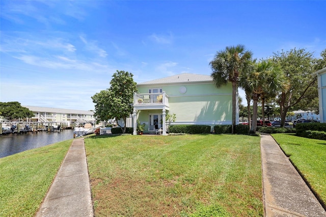 exterior space featuring a yard, a water view, and a balcony