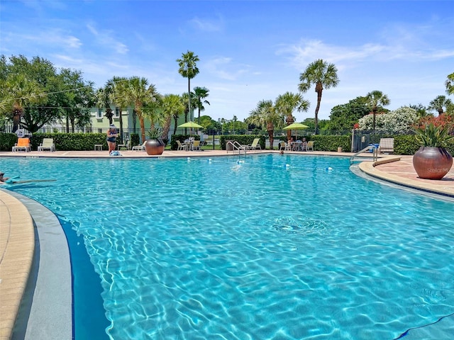 pool featuring fence and a patio