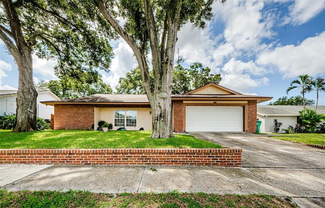 single story home featuring a front yard and a garage