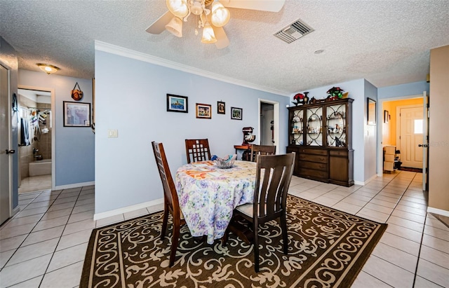 2208 Citrus Valley Cir, Palm Harbor, FL 34683 - dining area featuring a ceiling fan, a textured ceiling, light tile patterned floors, baseboards, and visible vents