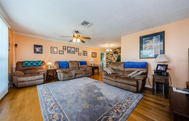 2208 Citrus Valley Cir, Palm Harbor, FL 34683 - living area with a textured ceiling, visible vents, ceiling fan with notable chandelier, and wood finished floors