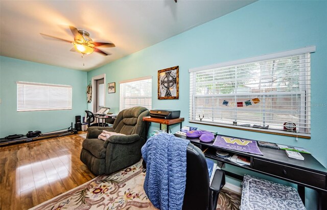 interior space featuring wood-type flooring and ceiling fan