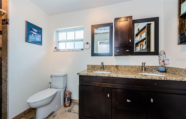 bathroom with vanity, toilet, and tile patterned floors