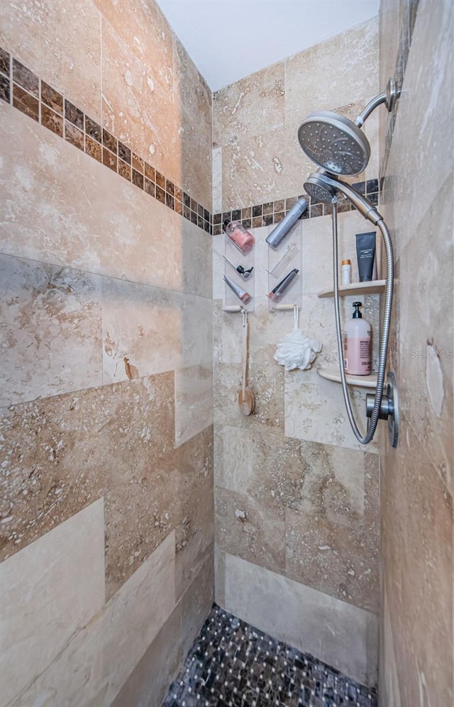 bathroom with a tile shower