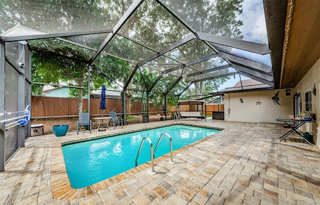 2208 Citrus Valley Cir, Palm Harbor, FL 34683 - view of swimming pool featuring glass enclosure, a fenced backyard, and a patio area