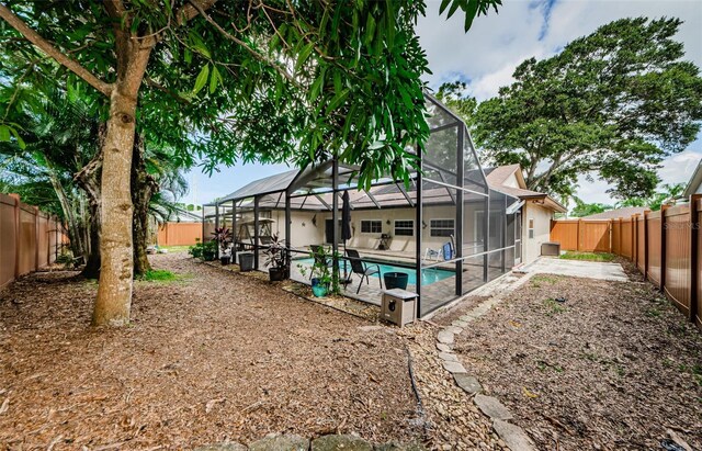 2208 Citrus Valley Cir, Palm Harbor, FL 34683 - back of house featuring a fenced backyard, a patio, and a fenced in pool