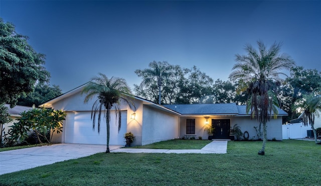 single story home with a yard and a garage