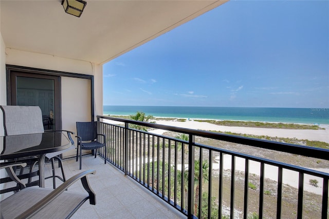 balcony featuring a water view and a view of the beach