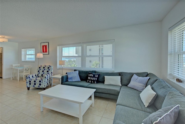 living room featuring a textured ceiling and light tile patterned flooring