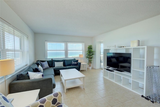 living room featuring light tile patterned floors and a textured ceiling