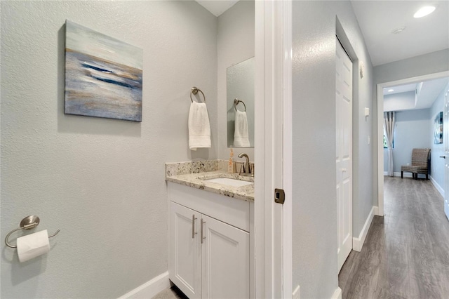 bathroom featuring wood-type flooring and vanity