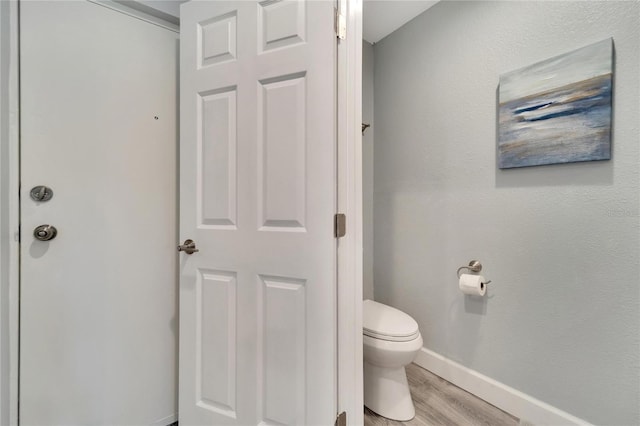 bathroom featuring toilet and hardwood / wood-style floors